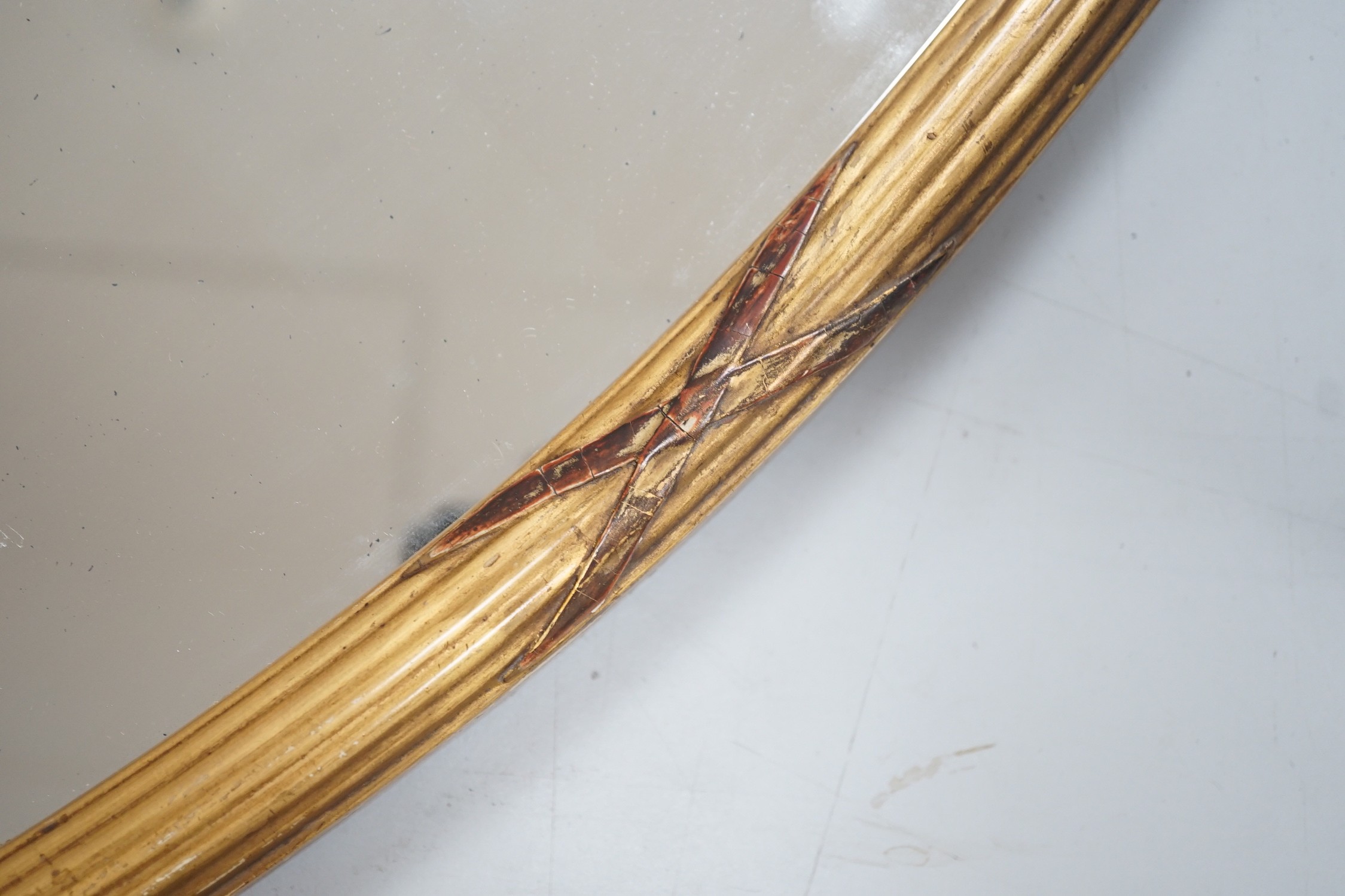 A Victorian oval giltwood framed mirror, 86x58cm